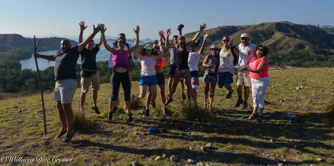 A group of people get excited for the camera in Komodo National Park