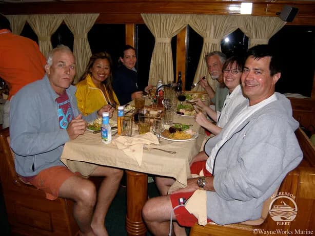 A group eating dinner aboard the Galapagos Aggressor III Liveaboard
