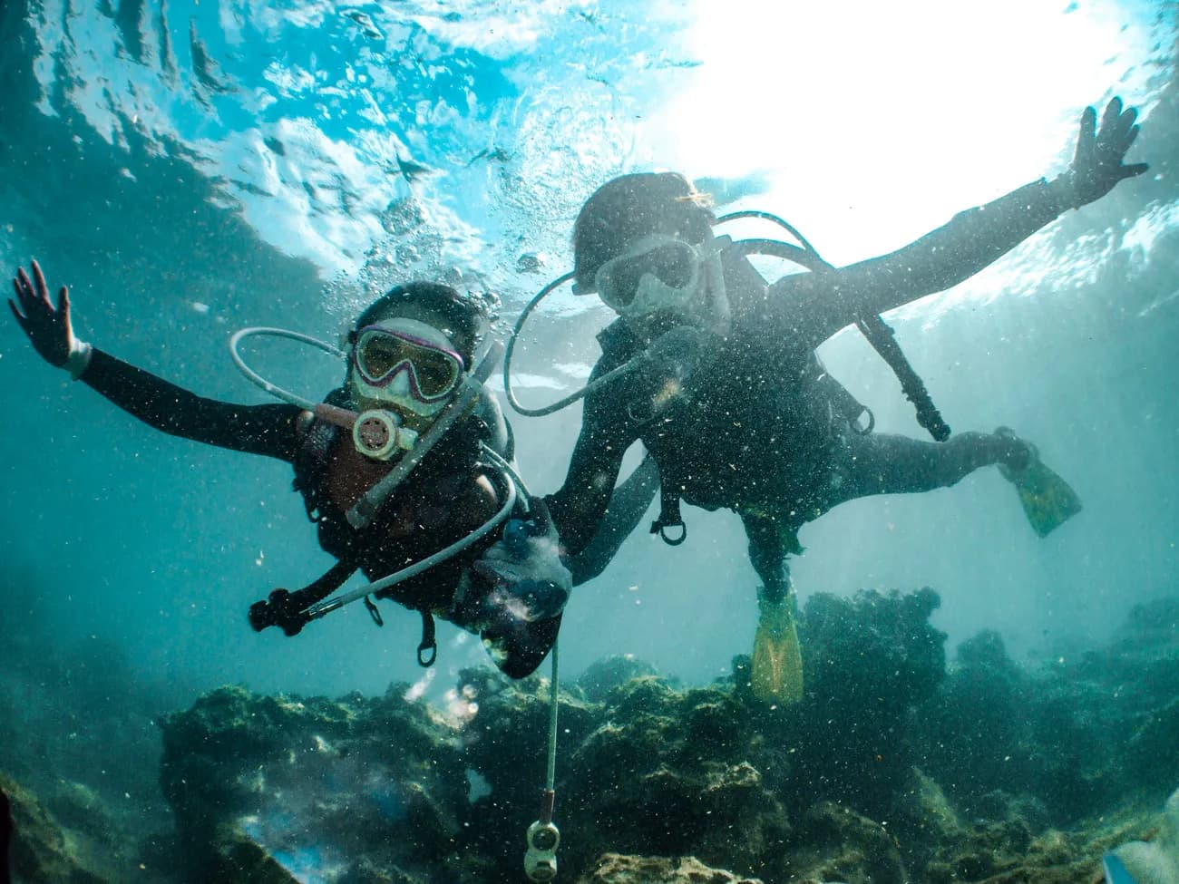 Two people scuba diving together at a family-friendly dive destination Two people scuba diving together at a family-friendly dive destination