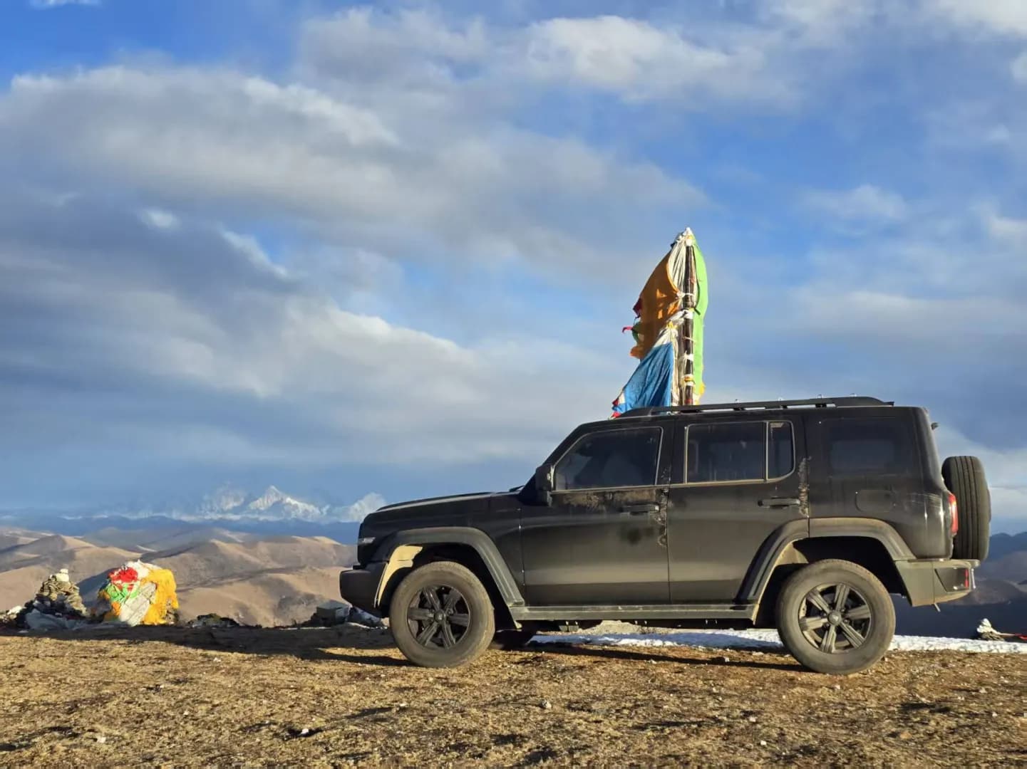 A 4x4 parked by a marker