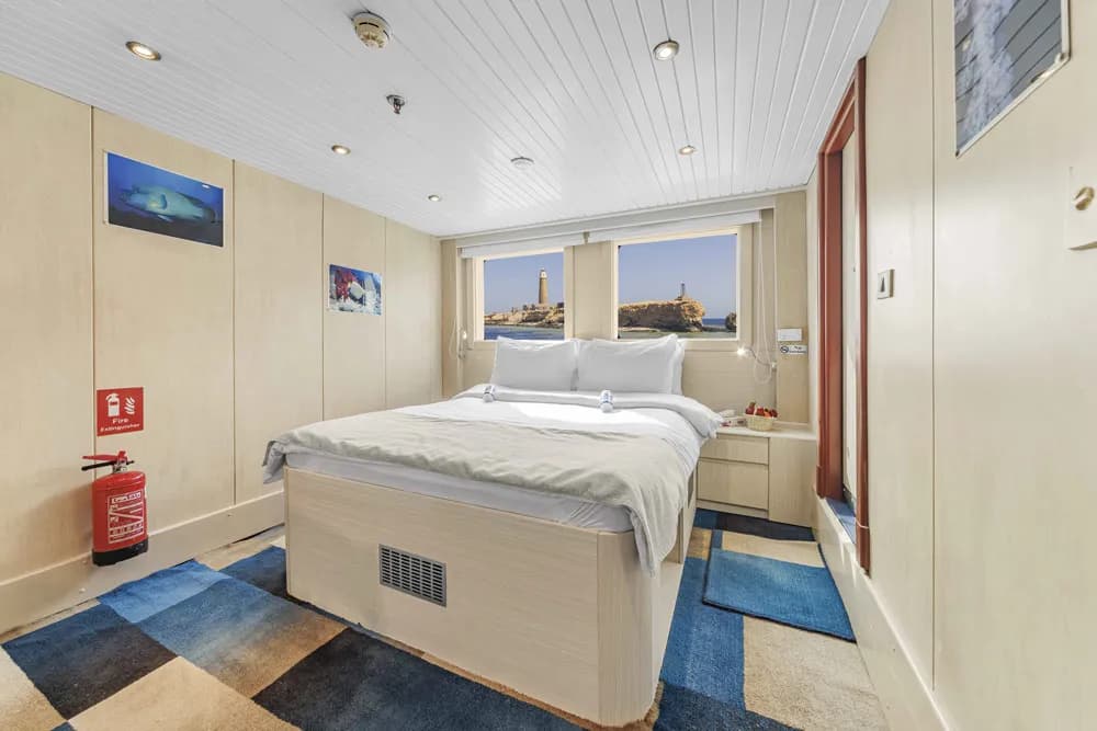 A double bed in a cabin on the Royal Evolution liveaboard in the Red Sea.