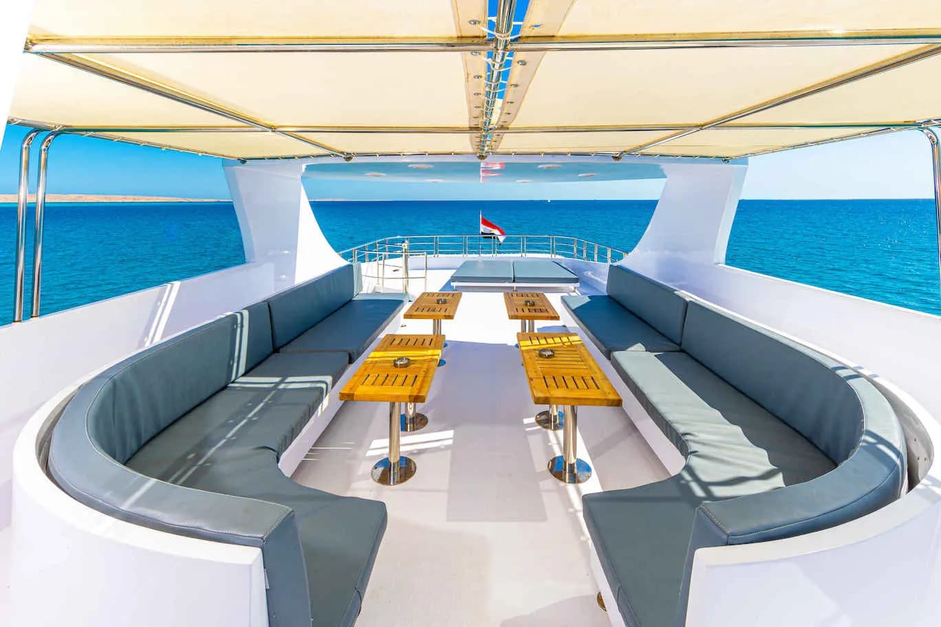 Shaded deck area with couches and a table