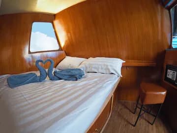 The Deluxe Cabin's large bed with a square window