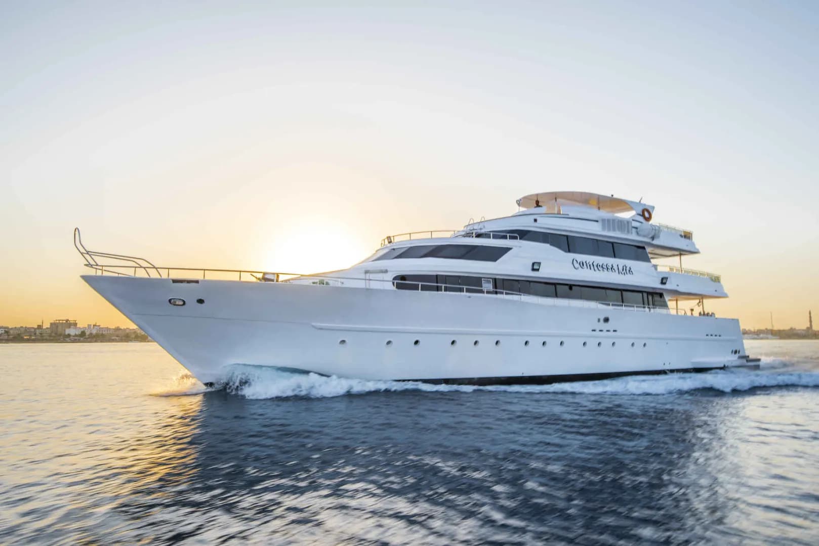 The Sea Serpent Contessa sails as the sun sets behind it