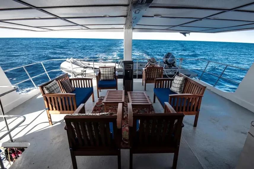 Deck of the Rocio del Mar Liveaboard featuring chairs and tables arranged for relaxation and dining.