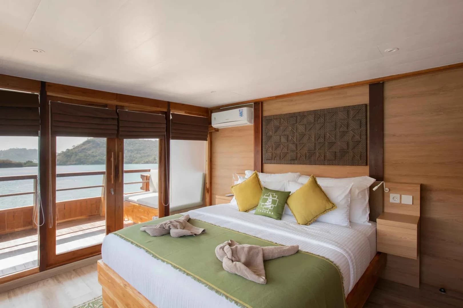 A double bed with green and yellow pillows