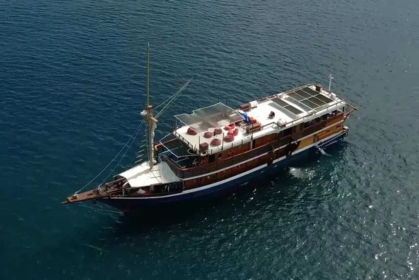A large boat named Mari Liveaboard featuring an expansive deck and spacious sun deck for relaxation.
