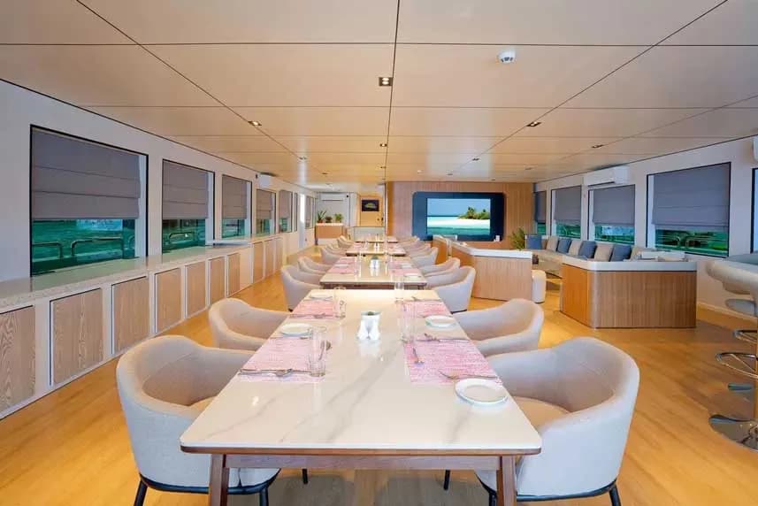 Elegant dining room on the Ariyal Liveaboard, featuring well-set tables and a welcoming atmosphere for guests.