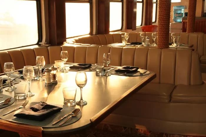 Dining tables set for dinner aboard the MV Valentina liveaboard.