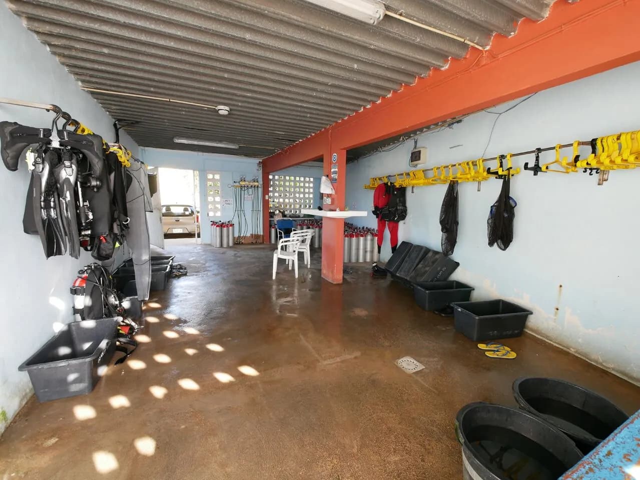 A room with scuba gear and a ladder, ready for underwater exploration.