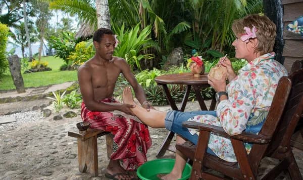 A woman enjoys a foot massage at Paradise Taveuni