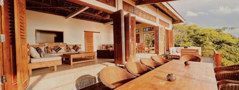 A lounge and long dining table at Alor Tanapi Dive Resort.